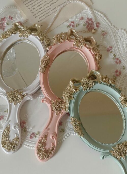 Oval-Shaped Hand Mirror with Gold Embellishment